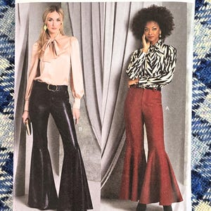 May include: Vogue Patterns sewing pattern featuring two models wearing flared pants. One model wears black leather-look pants, the other wears red pants. The pattern number is V1974, and the size range is H5 (6-8-10-12-14).