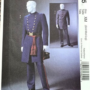 May include: A McCall's Costumes sewing pattern, M4745, featuring a navy blue military-style costume. The pattern includes a long coat with gold buttons, matching pants, and a red sash. The size is XM (Sml-Med-Lrg).