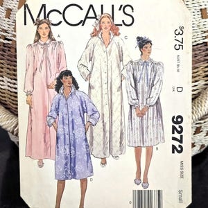 May include: A McCall's 9272 sewing pattern envelope featuring illustrations of four different robe styles. The designs include a long pink robe, a knee-length purple floral robe, a long white quilted robe, and a knee-length white patterned robe.