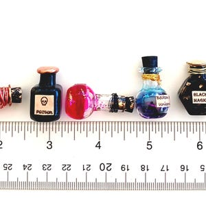 May include: A ruler with 10 potion bottles, each with a different color and design. The bottles are labeled with words like "Poison" and "Black Magic".