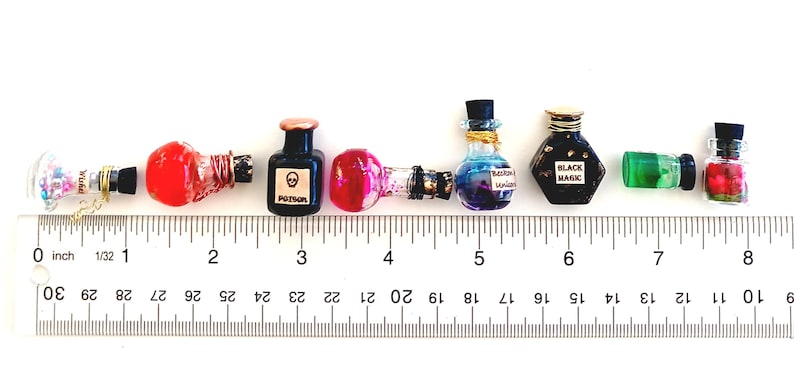 May include: A ruler with 10 potion bottles, each with a different color and design. The bottles are labeled with words like "Poison" and "Black Magic".