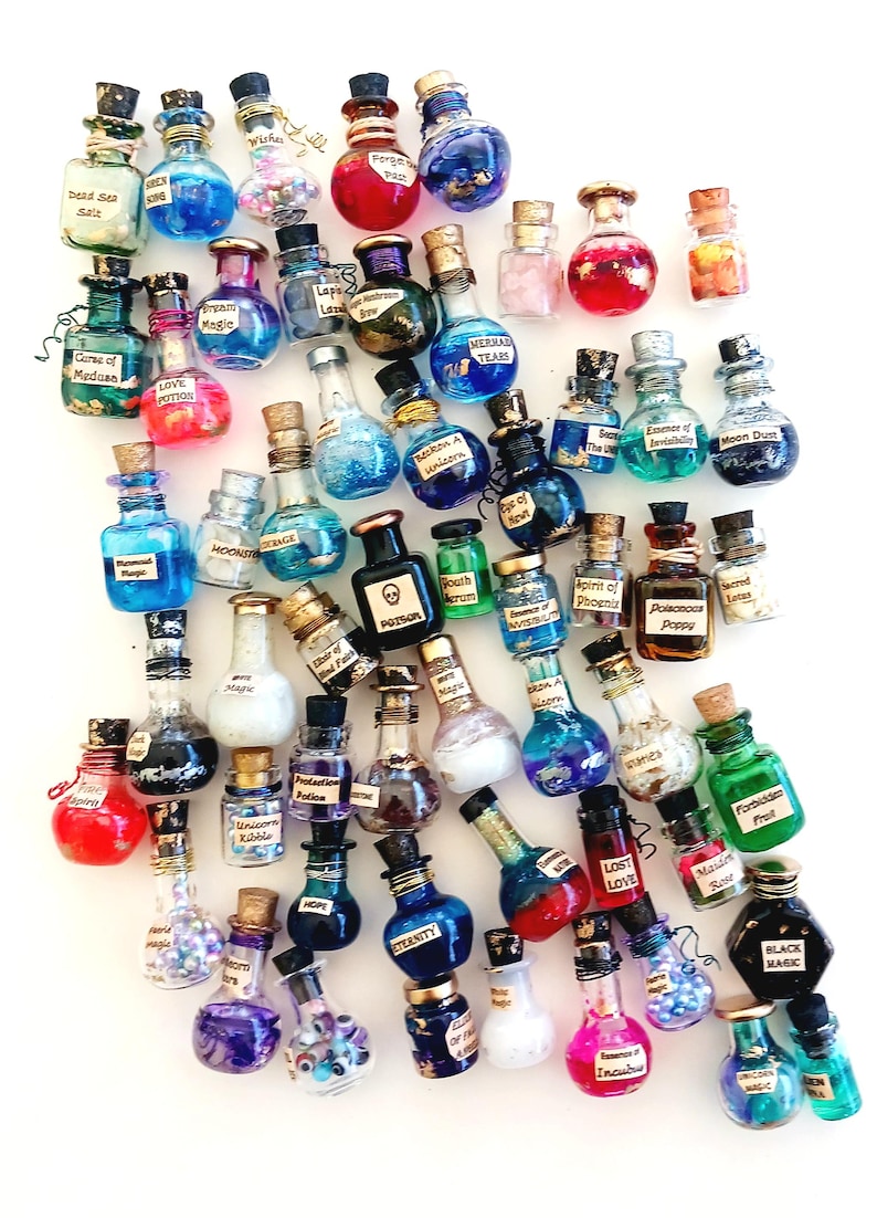 May include: A collection of small glass bottles with cork stoppers, filled with colorful liquids and glitter. Each bottle has a different label with a magical or mystical inscription, such as "Love Potion", "Mermaid Tears", and "Black Magic".