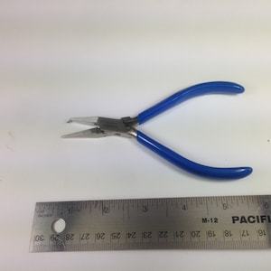 May include: Blue handled pliers with a silver metal body. The pliers have a small, pointed tip and are designed for jewelry making.