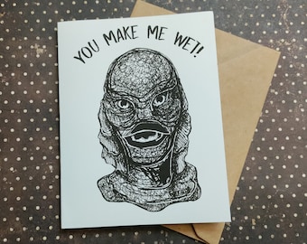 Può includere: Un biglietto bianco con testo nero che dice "You make me wet!" e un'illustrazione in bianco e nero della Creatura della Laguna Nera.