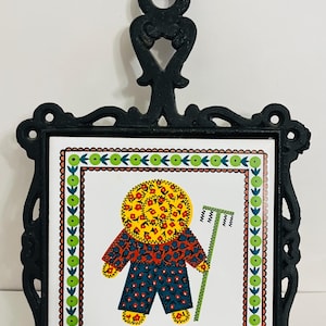 Vintage 1970s Cast Iron Trivet w Ceramic Tile Floral Calico Farmer Boy With Rake