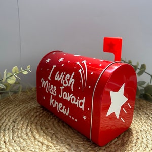 May include: Red metal mailbox with a white star and the text "I wish Miss Javaid knew..." on the front. The mailbox has a red flag with a white star on top.