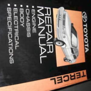 May include: A 1993 Toyota Tercel repair manual with a black and white cover featuring a photo of a silver car. The cover text reads "Repair Manual" and "1993 Toyota Tercel".