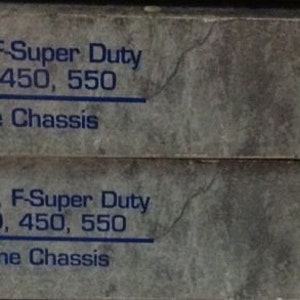 May include: Two grey and brown workshop manuals for 2001 Ford Excursion, F-Super Duty 250, 350, 450, 550 Motorhome Chassis. The top manual is labelled "Volume 1" and the bottom manual is labelled "Volume 2".