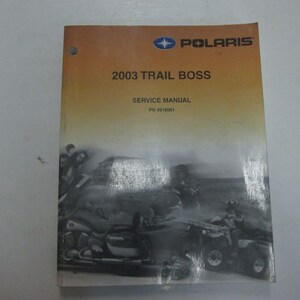 May include: A yellow and white Polaris Trail Boss service manual with a black and white photo of people riding ATVs. The manual is for the 2003 model year and has the part number 9918081.