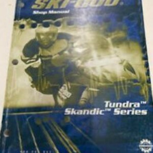 May include: A 2004 Ski-Doo Shop Manual for the Tundra and Skandic Series snowmobiles. The cover features a blue and white image of a snowmobile with a rider in a blue and white suit.