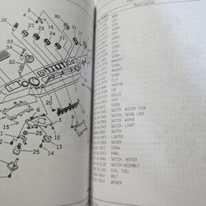 May include: A black and white diagram of a car dashboard with numbered parts labeled with their corresponding names. The diagram includes a variety of switches, buttons, and other components. The diagram is labeled "Fig. K0210-10A0".