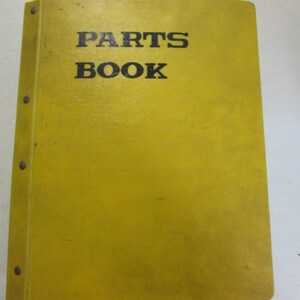 May include: Yellow binder with the text "PARTS BOOK" printed in black.