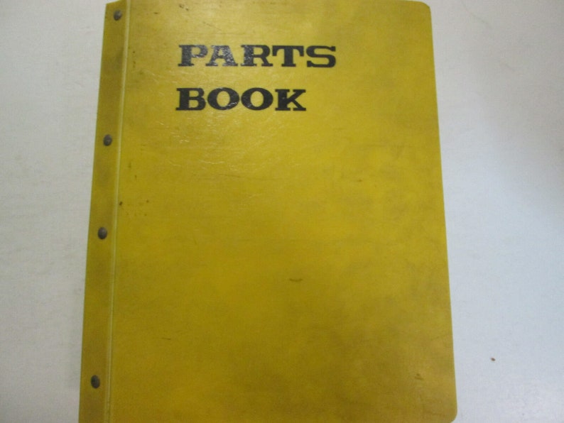May include: Yellow binder with the text "PARTS BOOK" printed in black.