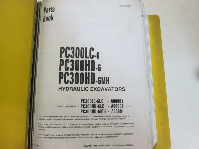 May include: A yellow and white parts book for Komatsu PC300LC-6, PC300HD-6, and PC300HD-6MH hydraulic excavators. The book lists serial numbers for each model.