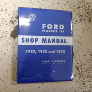 May include: A blue Ford Passenger Car Shop Manual covering the years 1952, 1953, and 1954. The manual is from the Ford Division of the Ford Motor Company.