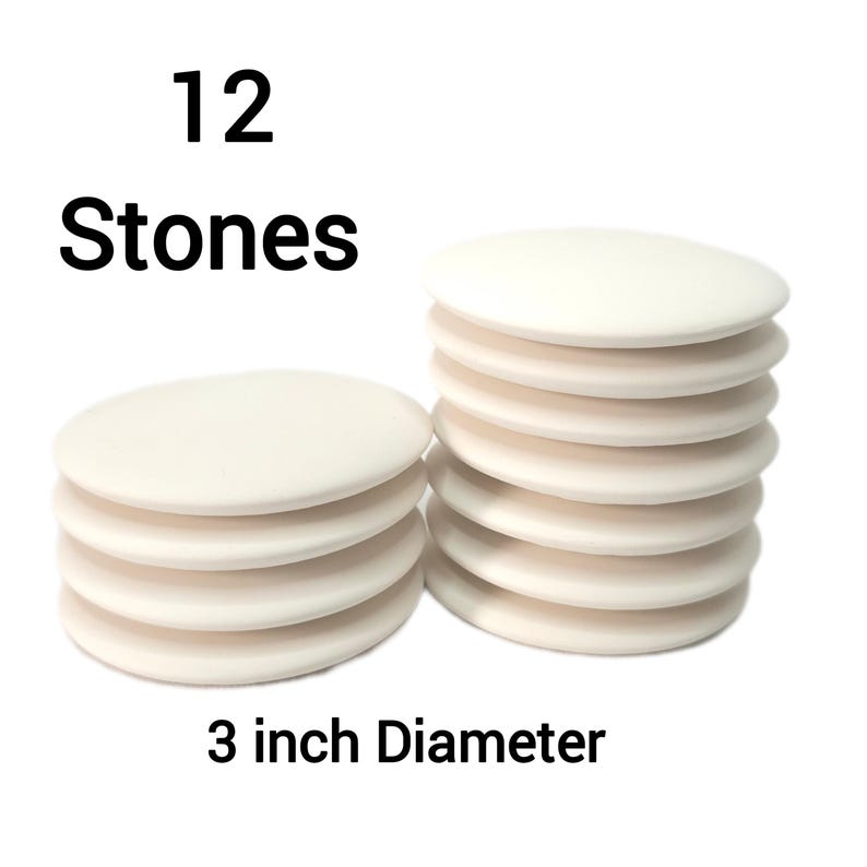 May include: Twelve white round 3 inch diameter stone coasters.