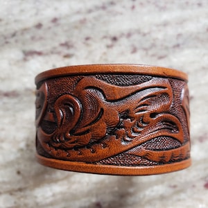 Hand tooled leather wrist band.