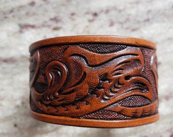 Hand tooled leather wrist band.