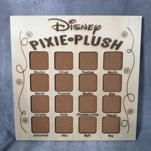 May include: Wooden Disney Pixie Plush display board with 16 square slots for plush toys. The board features the Disney logo and the words "PIXIE PLUSH". Each slot is labeled with a character's name, including Meeko, Oliver, and Pumbaa.