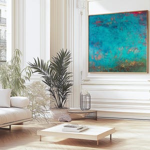 May include: A living room interior featuring a white sofa, potted plants, and a large abstract artwork in teal and red. The room has a modern design with light wood flooring and white walls.