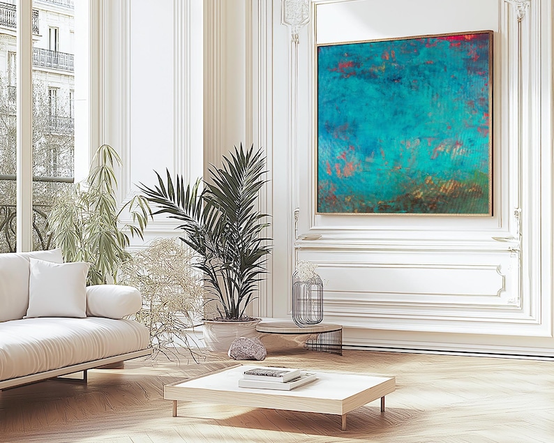 May include: A living room interior featuring a white sofa, potted plants, and a large abstract artwork in teal and red. The room has a modern design with light wood flooring and white walls.