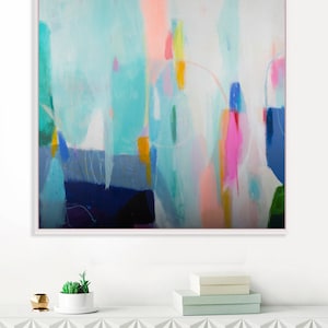 an Original abstract painting hanging on a wall above a white cabinet