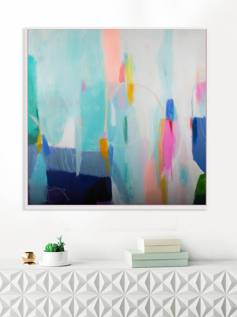 an Original abstract painting hanging on a wall above a white cabinet