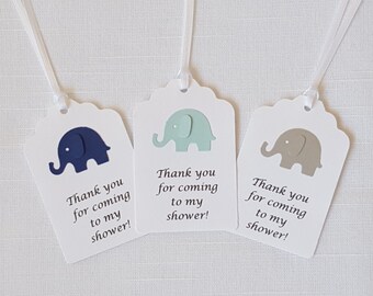 May include: Three white gift tags with blue, green, and gray elephant cutouts. Each tag has the text "Thank you for coming to my shower!"