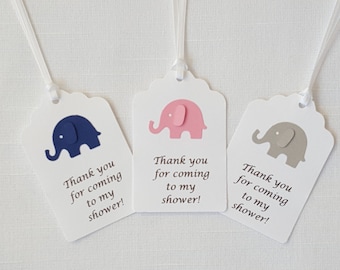 May include: Three white favor tags with scalloped edges and blue, pink, and gray paper elephants. Each tag has the text "Thank you for coming to my shower!"