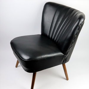 Great cocktail armchair in black leather from the 50s