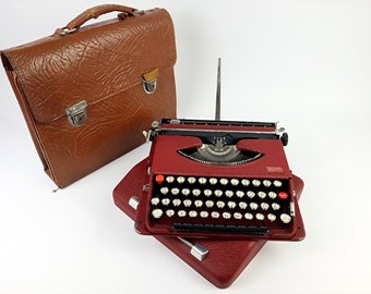 Gossen Tippa rood krullende lak vintage typemachine met originele Tippa lederen tas uit 1950 met gebruiksaanwijzing