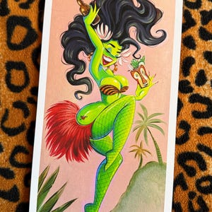 May include: Illustration of a green-skinned woman with black hair, wearing a bikini top and fishnet stockings, holding a bottle and a tiki drink. She has a red feather skirt and is set against a pink background with palm trees. Signed "Candy '23".