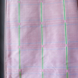 May include: Pink fabric with a checkered pattern in shades of blue, green, and red.