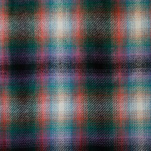 May include: A close-up of a fabric with a plaid pattern in shades of green, red, pink, and white.