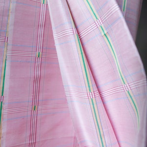 May include: Pink fabric with a checkered pattern in white, blue, green, and yellow.