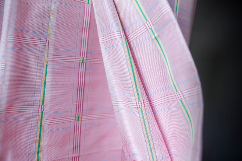 May include: Pink fabric with a checkered pattern in white, blue, green, and yellow.