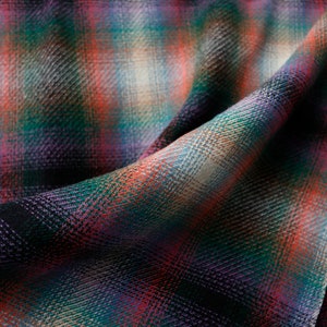 May include: Close-up of a soft, woven fabric with a plaid pattern in shades of red, green, purple, and white.