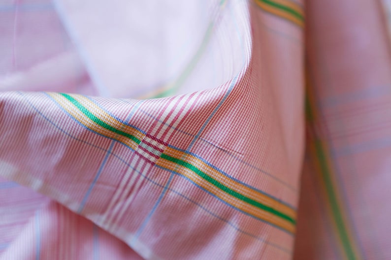 May include: Pink fabric with a checkered pattern in shades of pink, blue, yellow, and green.
