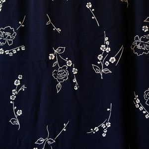 Navy blue vintage textured synthetic fabric w flocked off-white flowers