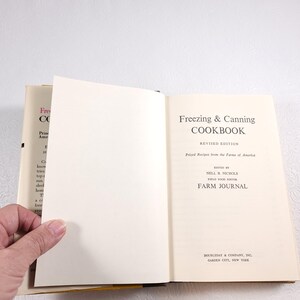 May include: A vintage cookbook titled "Freezing & Canning Cookbook" with a revised edition label. The book features a white cover with black text and is published by Farm Journal.