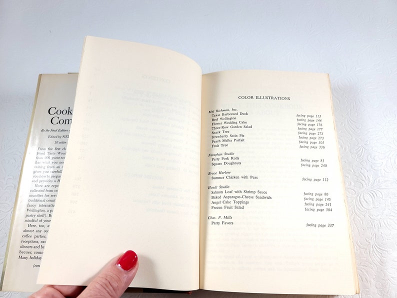 May include: Open cookbook with a list of color illustrations, including recipes like Texas Barbecued Duck and Strawberry Soda Pie. The book's cover is visible on the left, with the title "Cook Complete".