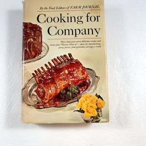 May include: A vintage cookbook titled "Cooking for Company" by the Food Editors of Farm Journal. The cover features images of a roasted meat dish, a chocolate cake, and yellow roses in a glass vase. The book promises extra-delicious recipes and entertaining ideas.
