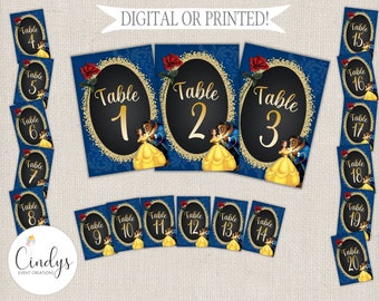 May include: A set of 20 printable table number cards featuring a Beauty and the Beast theme. The cards are blue with gold glitter and feature a silhouette of Belle and the Beast dancing. The numbers are in gold and the text "Table" is in black.