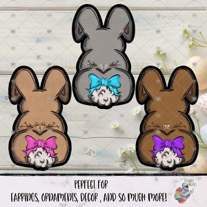 May include: Three bunny-shaped ornaments in shades of gray and brown, each with a fluffy tail and a bow. The text "PERFECT FOR EARRINGS, ORNAMENTS, DECOR, AND SO MUCH MORE!" is at the bottom.