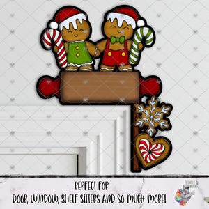 May include: A decorative wooden corner sign featuring two gingerbread characters wearing Santa hats, one in a green dress and one in red overalls. They hold candy canes above a brown rolling pin. A snowflake and a heart-shaped cookie hang below.