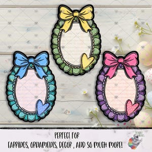 以下が含まれることがあります： リボンとハートのアクセントが付いた、3つの装飾的な楕円形のデザイン。 デザインはスカラップのボーダーが特徴で、青、緑、紫の色合いです。 下部のテキストは「PERFECT FOR EARRINGS, ORNAMENTS, DECOR, AND SO MUCH MORE!」と書かれています。