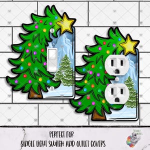 May include: Christmas-themed light switch and outlet covers. The covers feature a green Christmas tree design with colorful ornaments and a yellow star. The background shows a winter scene with mountains and trees. The text at the bottom reads "PERFECT FOR SINGLE LIGHT SWITCH AND OUTLET COVERS."
