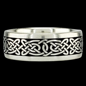 May include: A silver ring with a black Celtic knot design.