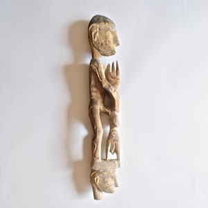 Wood Carved Asmat Male Figure Standing on Ancestor’s Head A Tribal Artifact from Papua New Guinea-Lot 23