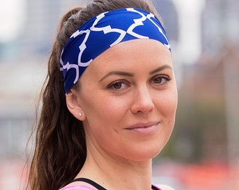May include: A woman wearing a blue and white patterned headband with a pink tank top.